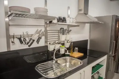 a kitchen with a microwave and a refrigerator at Vivian's Guest House Auto Check-in in Jerez de la Frontera