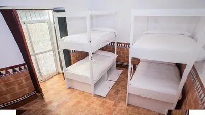 a room with two bunk beds and a sink at Vivian's Guest House Auto Check-in in Jerez de la Frontera