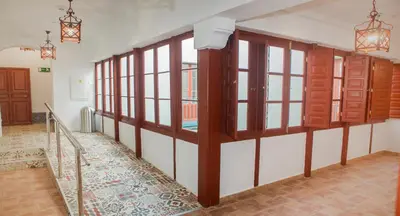 a hallway with a clock on the wall and a door at Vivian's Guest House Auto Check-in in Jerez de la Frontera