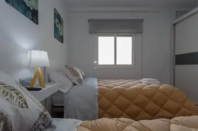 a bedroom with a bed and a desk and a window at El TESORO de la Caleta by Cadiz4Rentals in Cádiz