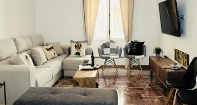 a living room with a couch and a table at GATU PREMIUM Villa Aramburu, 