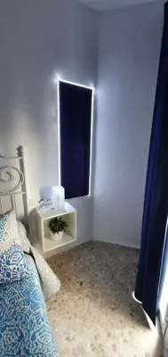 a white room with a bed and a window at Duplex Calle Padre Lerchundi con Parking y wifi in Chipiona