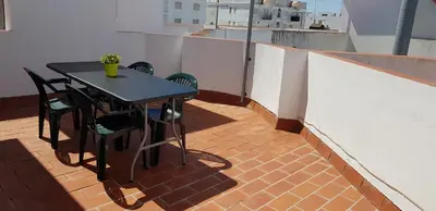 a black table and chairs on a balcony at Duplex Calle Padre Lerchundi con Parking y wifi in Chipiona