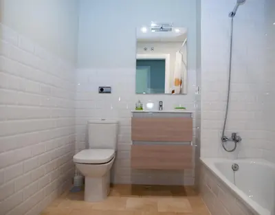 a bathroom with a toilet and a sink and a tub at La Casa del Arte in Cádiz