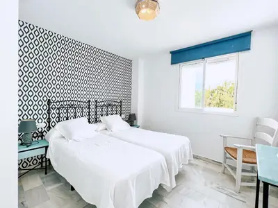 a white bedroom with a bed and a window at Retama Golf Nº 55 by Fontanilla Del Mar Holidays Rentals in Chiclana de la Frontera