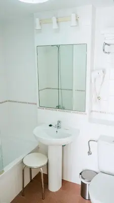 a white bathroom with a sink and a mirror at Retama Golf Nº 55 by Fontanilla Del Mar Holidays Rentals in Chiclana de la Frontera