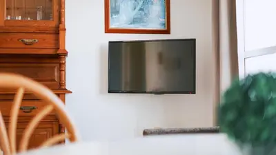 a flat screen tv hanging on a wall at Retama Golf Nº 55 by Fontanilla Del Mar Holidays Rentals in Chiclana de la Frontera
