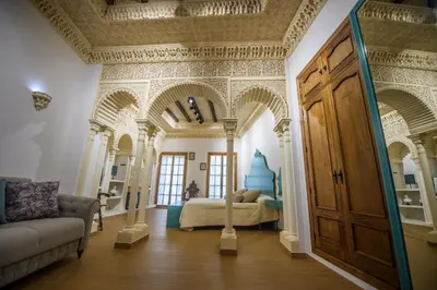 a bedroom with a bed in a room with arches at Casa Boutique Sanlucar in Sanlúcar de Barrameda