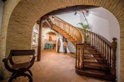 a woman walking down a staircase in a house at Casa Boutique Sanlucar in Sanlúcar de Barrameda