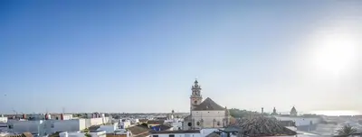 a view of a city with a clock tower at Casa Boutique Sanlucar in Sanlúcar de Barrameda