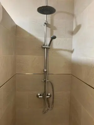 a shower with a shower head in a bathroom at Casa Conchita in Cádiz