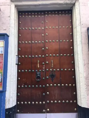 a large wooden door in a building at Casa Conchita in Cádiz