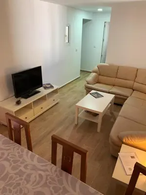 a living room with a couch and a flat screen tv at Casa Conchita in Cádiz