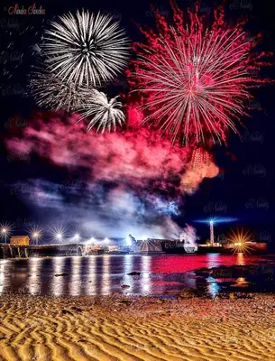 a firework display on the beach with a crowd of people at Casa Conchita in Cádiz