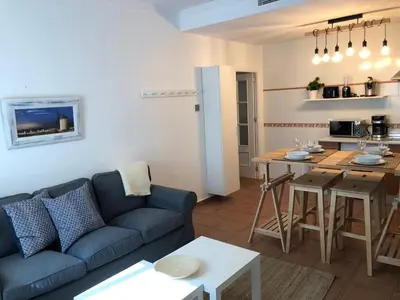 a living room with a couch and a table at Chipiona Acogedor in Chipiona