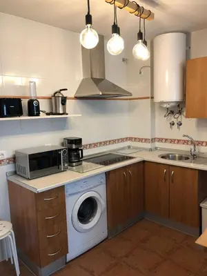 a kitchen with a washing machine in a kitchen at Chipiona Acogedor in Chipiona