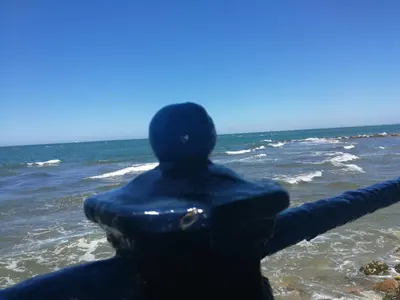 a man in a wetsuit looking out at the ocean at Chipiona Acogedor in Chipiona