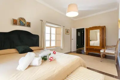 a bedroom with a large bed with two pillows at Suite Catedral Jerez in Jerez de la Frontera