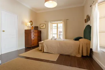 a bedroom with a bed and a dresser and a window at Suite Catedral Jerez in Jerez de la Frontera