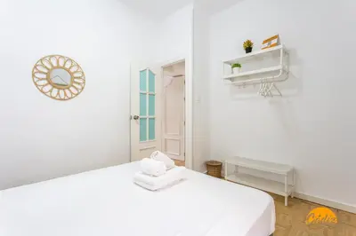 a white room with a white bed and a window at Garcia Rooms by Cadiz Time in Cádiz