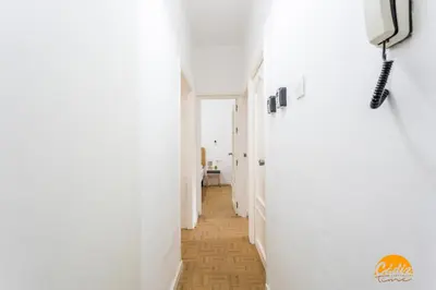 a hallway with white walls and wooden floors at Garcia Rooms by Cadiz Time in Cádiz