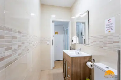 a bathroom with a sink and a mirror at Garcia Rooms by Cadiz Time in Cádiz
