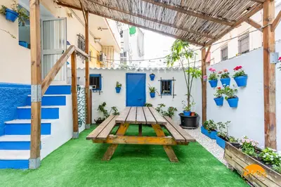 a picnic table in the courtyard of a house at Garcia Rooms by Cadiz Time in Cádiz