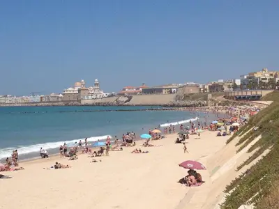 a large group of people on a beach at Jano PuertaTierra in Cádiz