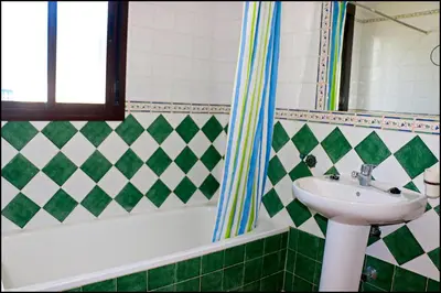 a bathroom with a sink and a bath tub at Chalet con piscina privada in Conil de la Frontera