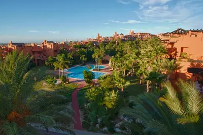 an aerial view of a resort with a pool and palm trees at Aparthotel Novo Resort in Chiclana de la Frontera