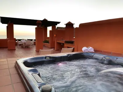 a hot tub on the patio of a house at Aparthotel Novo Resort in Chiclana de la Frontera