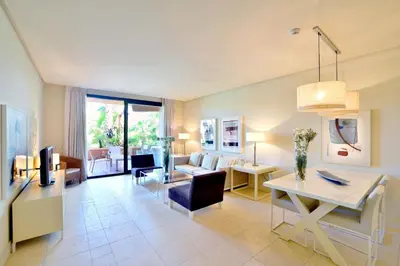 a living room with a couch and a table at Aparthotel Novo Resort in Chiclana de la Frontera