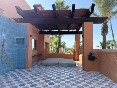 a patio with a bed in a house at Aparthotel Novo Resort in Chiclana de la Frontera