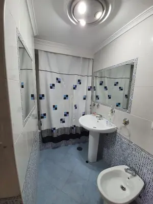 a white bathroom with a sink and a shower at Precioso piso al lado de la playa in Cádiz