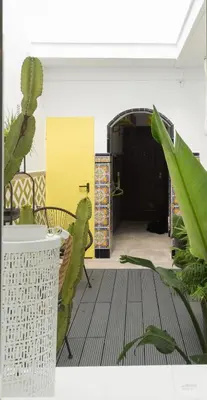 a room with a yellow door and some plants at Bohórquez Rooms by Ático73 in Medina Sidonia