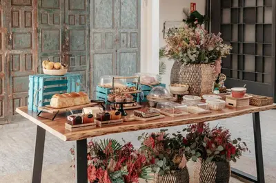 a room with a kitchen with a couch and a television at ASTUTO Boutique Jerez - Adults Only in Jerez de la Frontera