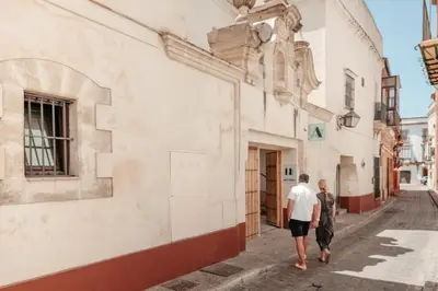 two men walking down a street in an alley at ASTUTO Boutique Jerez - Adults Only in Jerez de la Frontera