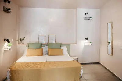 a bedroom with a bed with two pillows on it at ASTUTO Boutique Jerez - Adults Only in Jerez de la Frontera