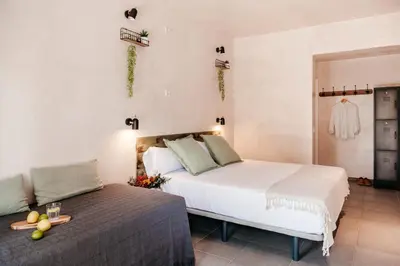 a hotel room with a bed and a couch at ASTUTO Boutique Jerez - Adults Only in Jerez de la Frontera