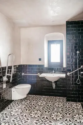 a bathroom with a sink and a tub and a toilet at ASTUTO Boutique Jerez - Adults Only in Jerez de la Frontera