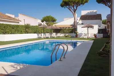 a swimming pool in the yard of a house at Villas La Barrosa in Chiclana de la Frontera