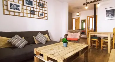 a living room with a couch and a wooden table at Apartamento Rústico_Centrico in El Puerto de Santa María