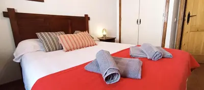 a bedroom with a bed with towels on it at Apartamento Rústico_Centrico in El Puerto de Santa María