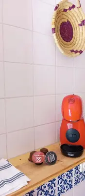 an orange coffee maker on a wooden shelf in a kitchen at Apartamento Rústico_Centrico in El Puerto de Santa María