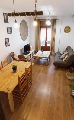 a living room with a table and a couch at Apartamento Rústico_Centrico in El Puerto de Santa María