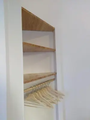 a closet with wooden shelves in a white wall at Azafran Jerez apartamentos in Jerez de la Frontera