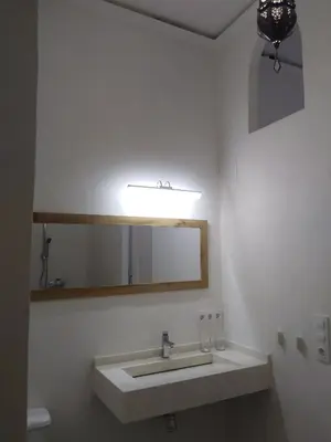 a bathroom with a sink and a mirror at Azafran Jerez apartamentos in Jerez de la Frontera