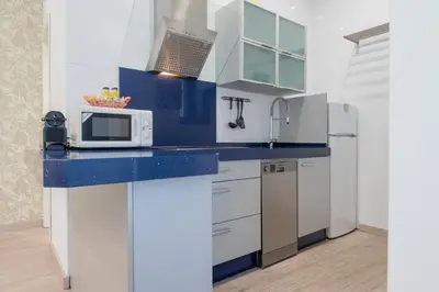 a kitchen with a blue counter top with a microwave at Panther Home Aladro III in Jerez de la Frontera