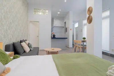 a bedroom with a bed and a living room at Panther Home Aladro III in Jerez de la Frontera