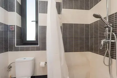 a bathroom with a shower with a toilet and a mirror at Panther Home Aladro V in Jerez de la Frontera